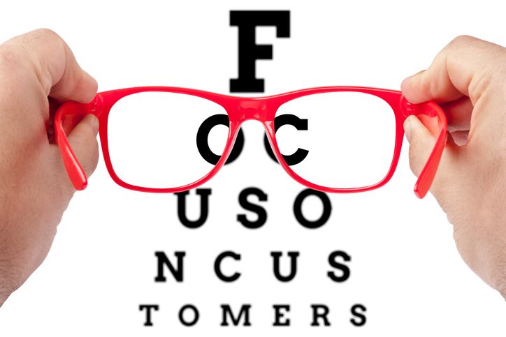 Red spectacles focusing on text focused on customers arranged as eye chart test