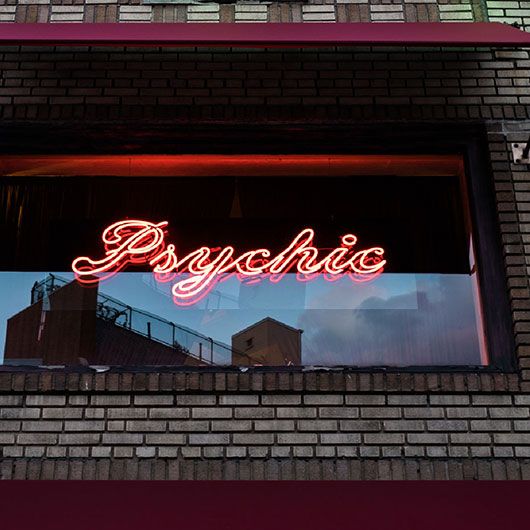 Window with neon sign that says Psychic