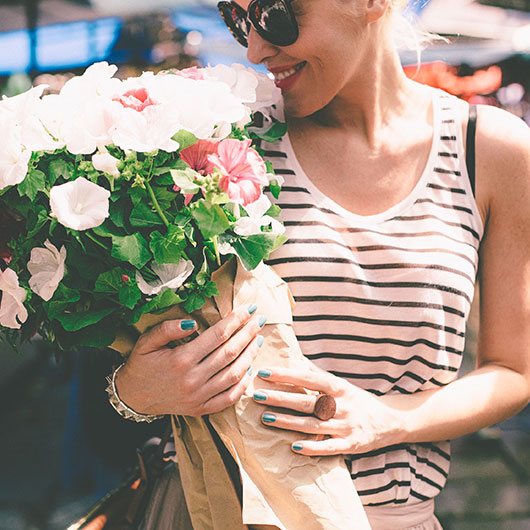 Woman smiling holding a bouquet of flowers