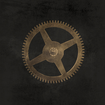 Gold mechanical gear on top of textured charcoal background