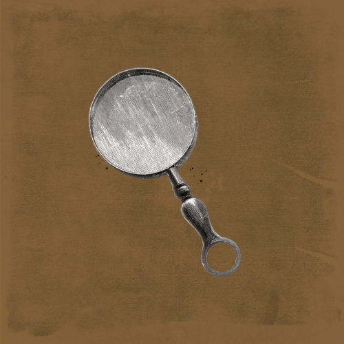 Antique magnifying glass on top of gold background